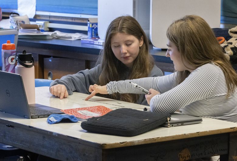 students in classroom with math textbooks and computers