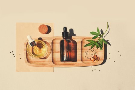 cannabis essential oils arranged on wooden table