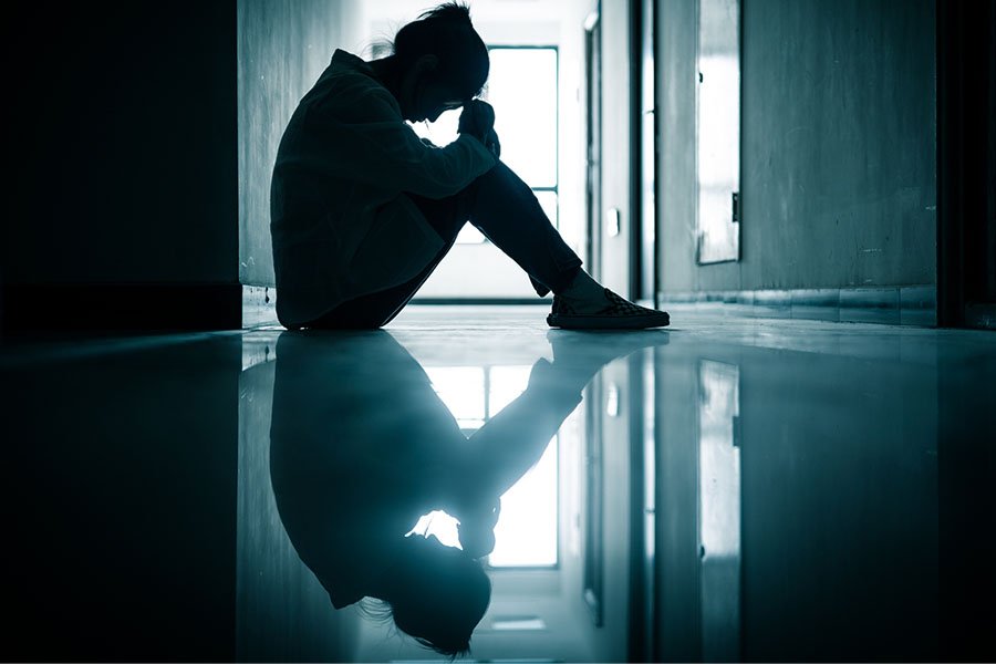 A person looking isolated, representing the impact of loneliness on mental health.
