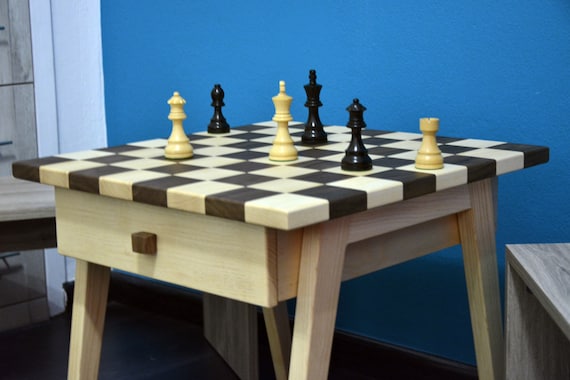 chess board pieces on wooden table