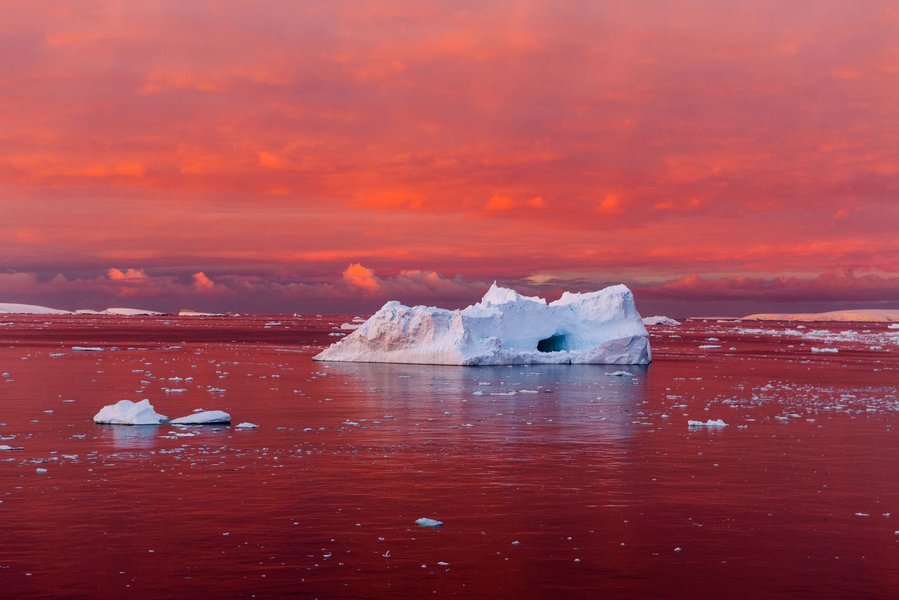 melting ice glaciers and sunset over ocean