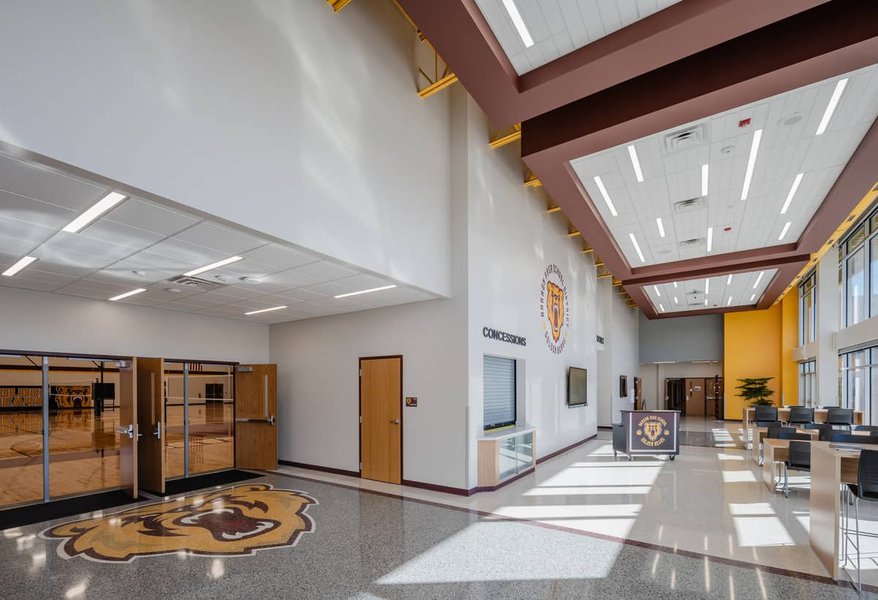 Modern school library with ample lighting and resources, representing positive physical infrastructure