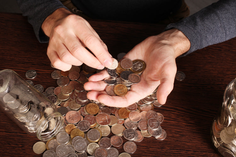 physical coins and cash registers on a table