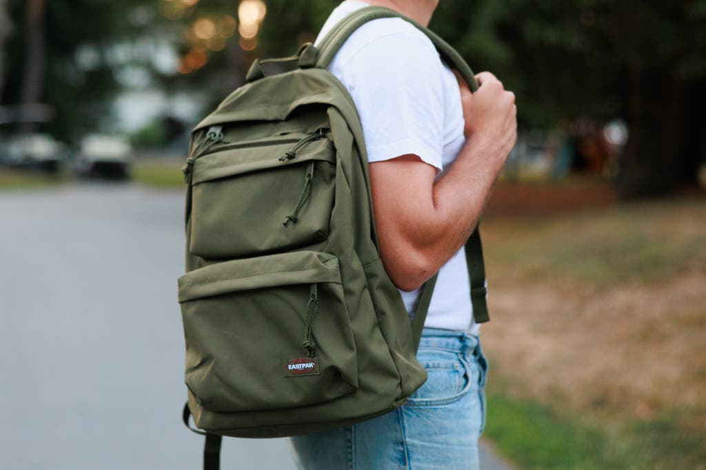 college bag on campus with books and laptop
