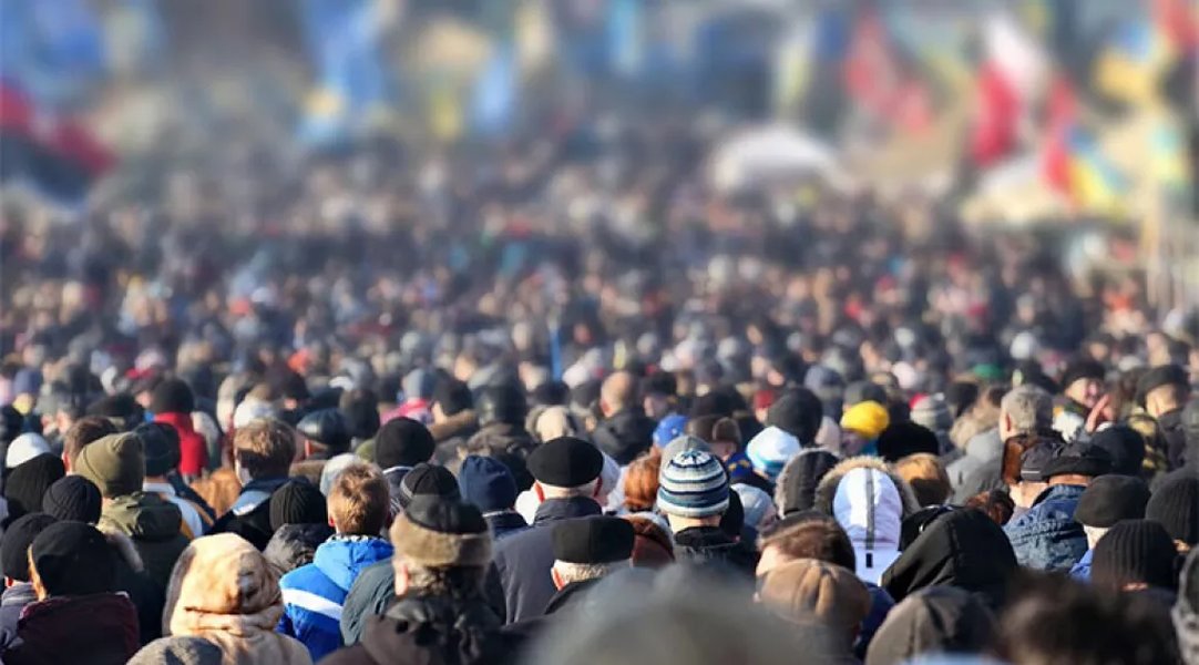Large crowd representing global population and governance challenges