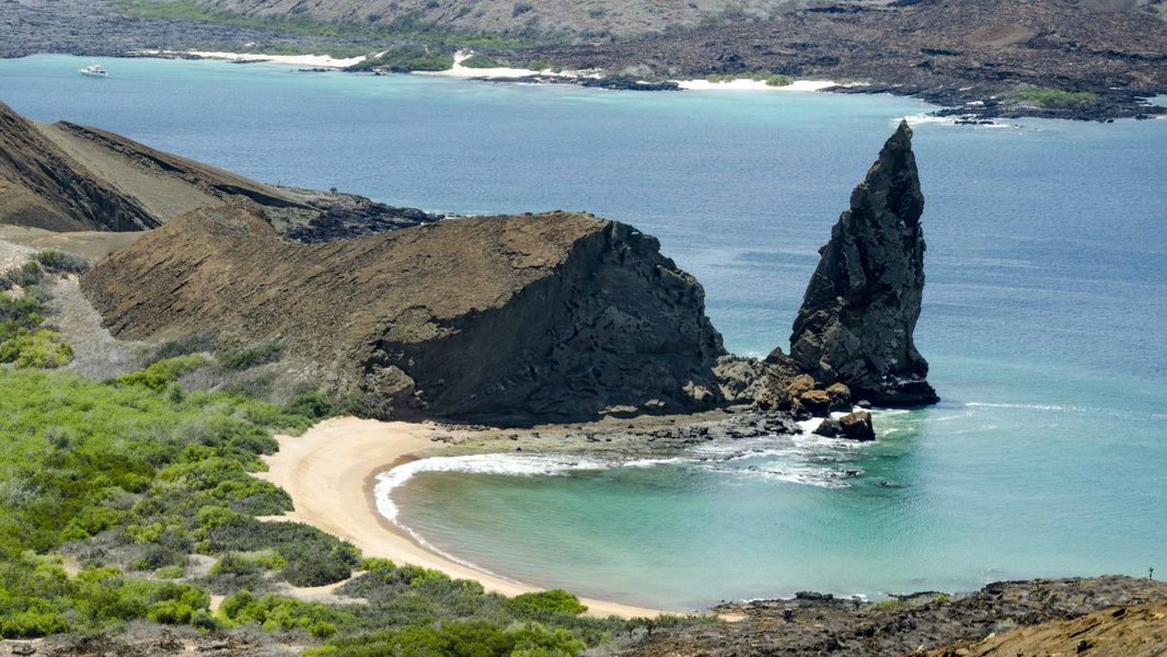 Volcanic landscape of Bartolome Island in the Galapagos, showing stark volcanic cones and lava fields
