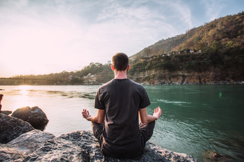 person meditating nature
