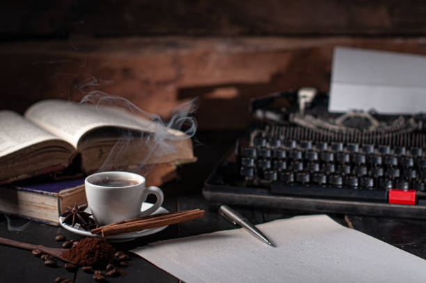 scenic view of writing desk with notebooks and coffee