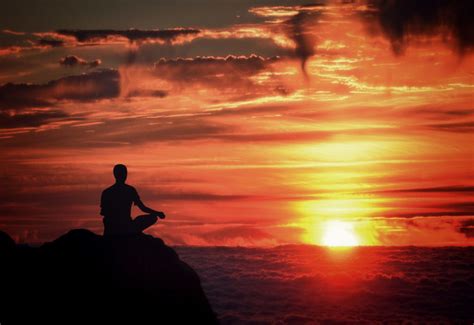 person meditating in nature