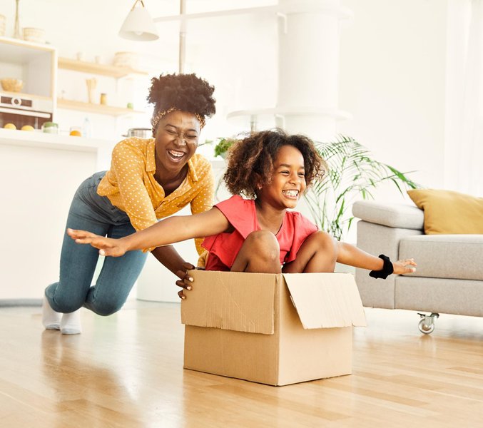 Movers carefully wrapping and moving furniture items