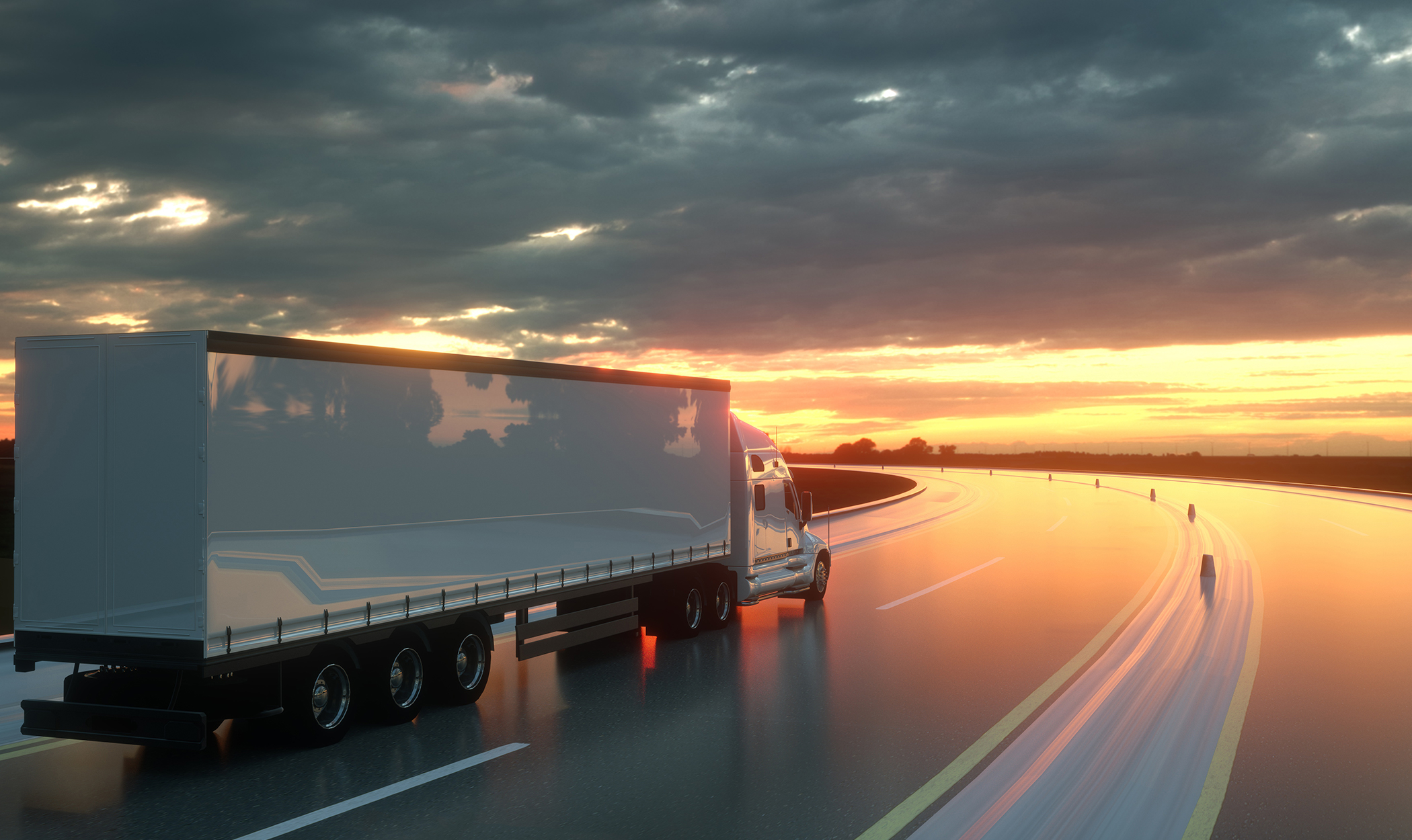 transport trucks on highway sunset