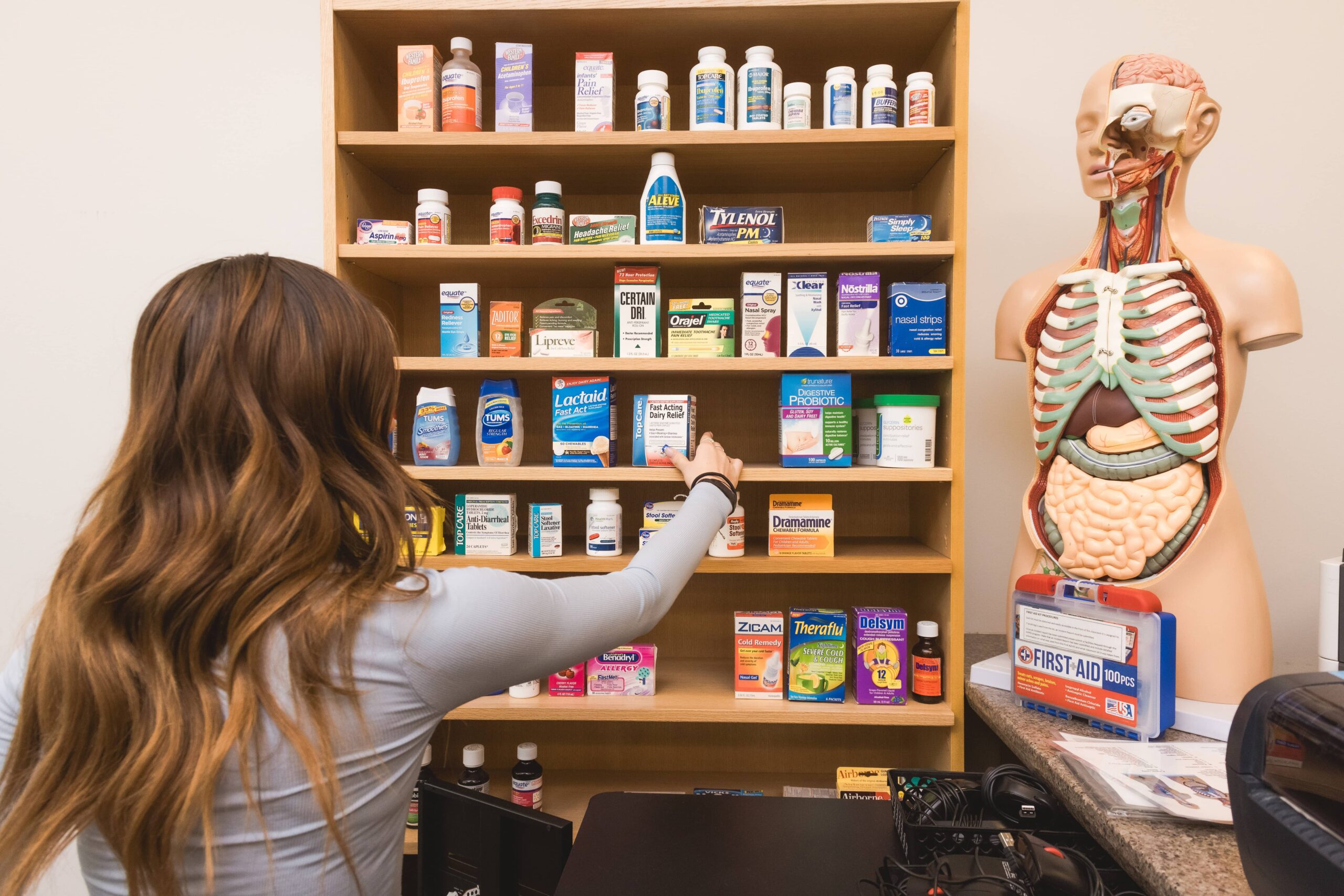 pharmacy technician study materials and medication shelves