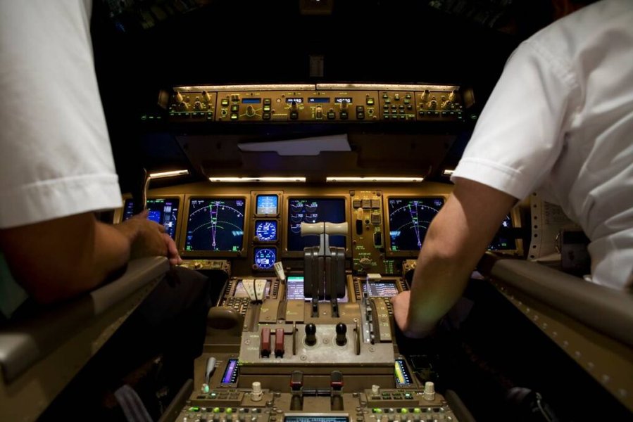 Pilots collaborating during a flight simulation training session