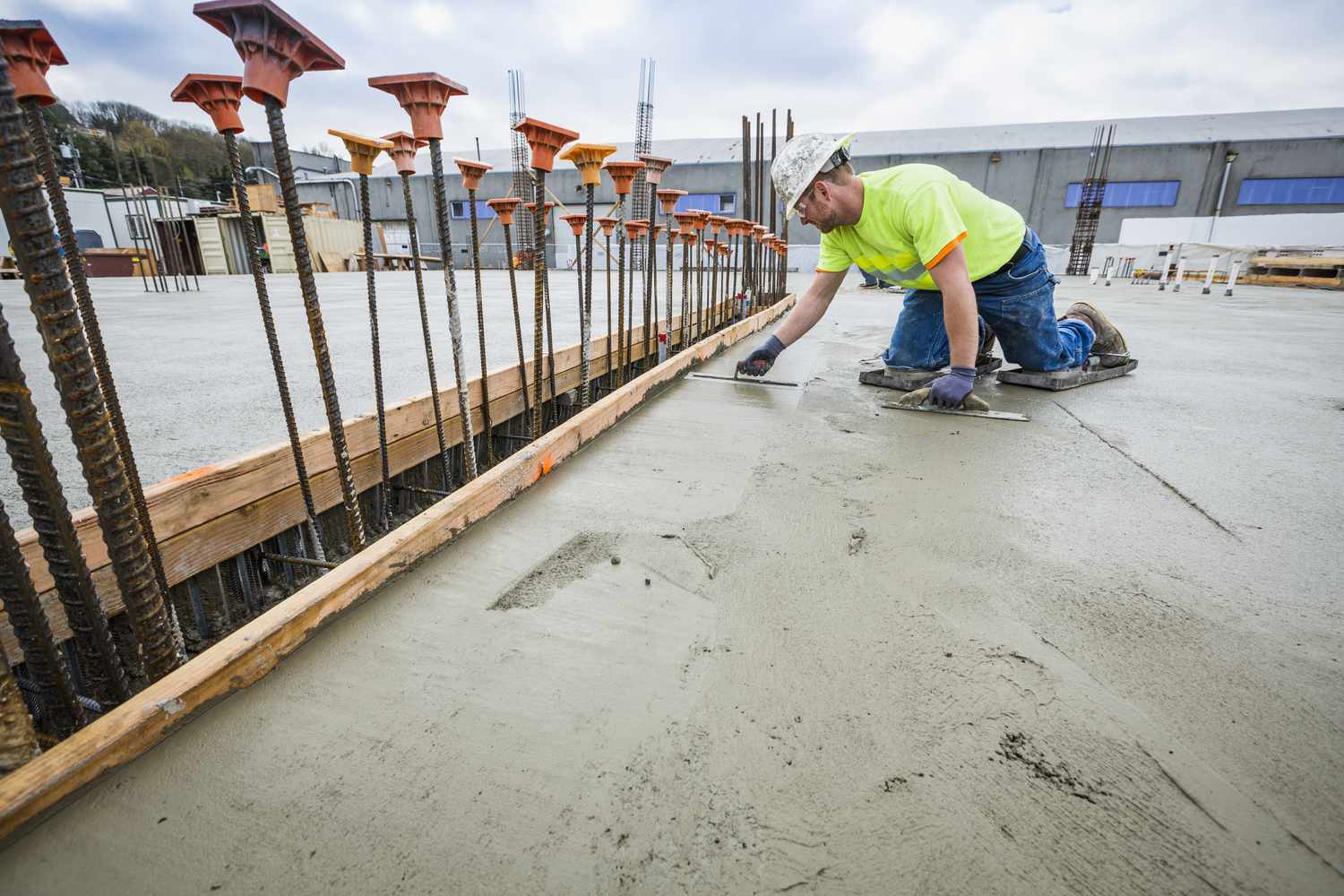 concrete curing process with workers constructing a building