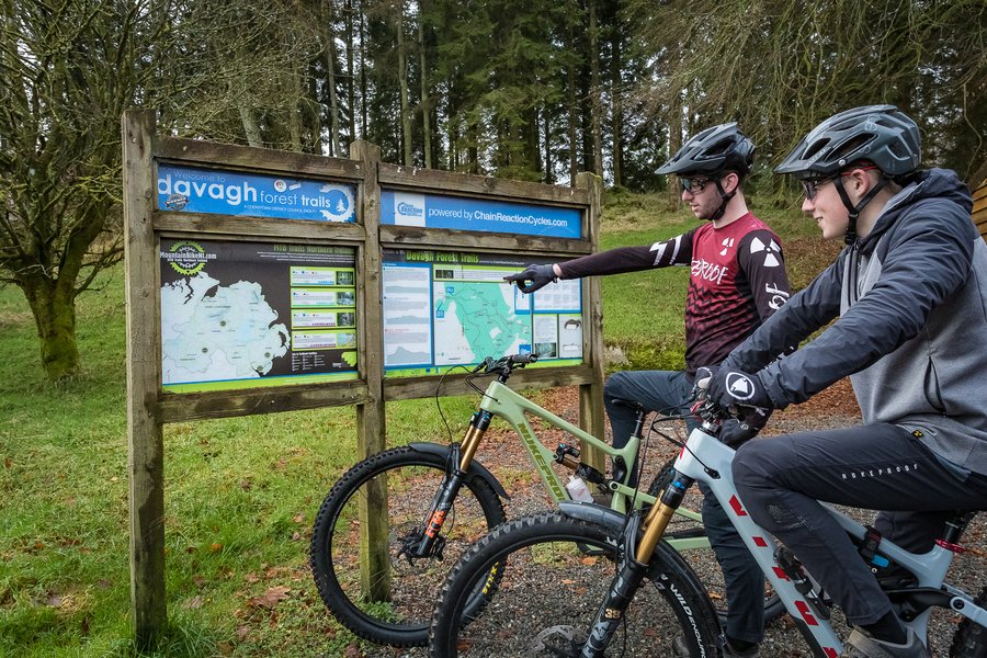 A group of mountain bikers riding on a dirt trail.
