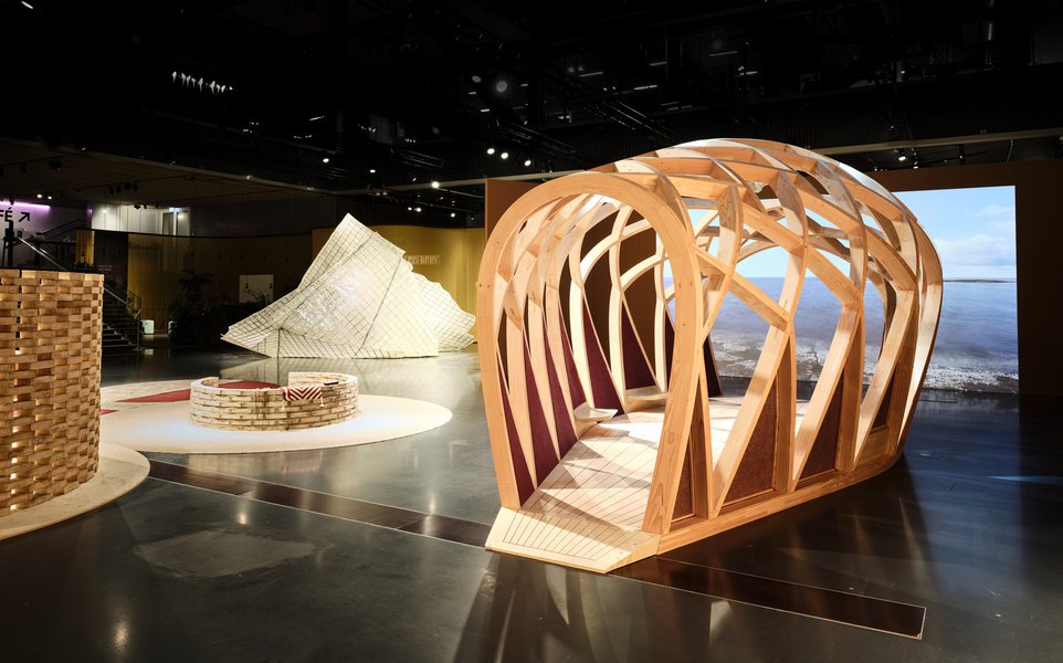Interior of a modern timber pavilion in Denmark, showcasing complex wood joinery and design