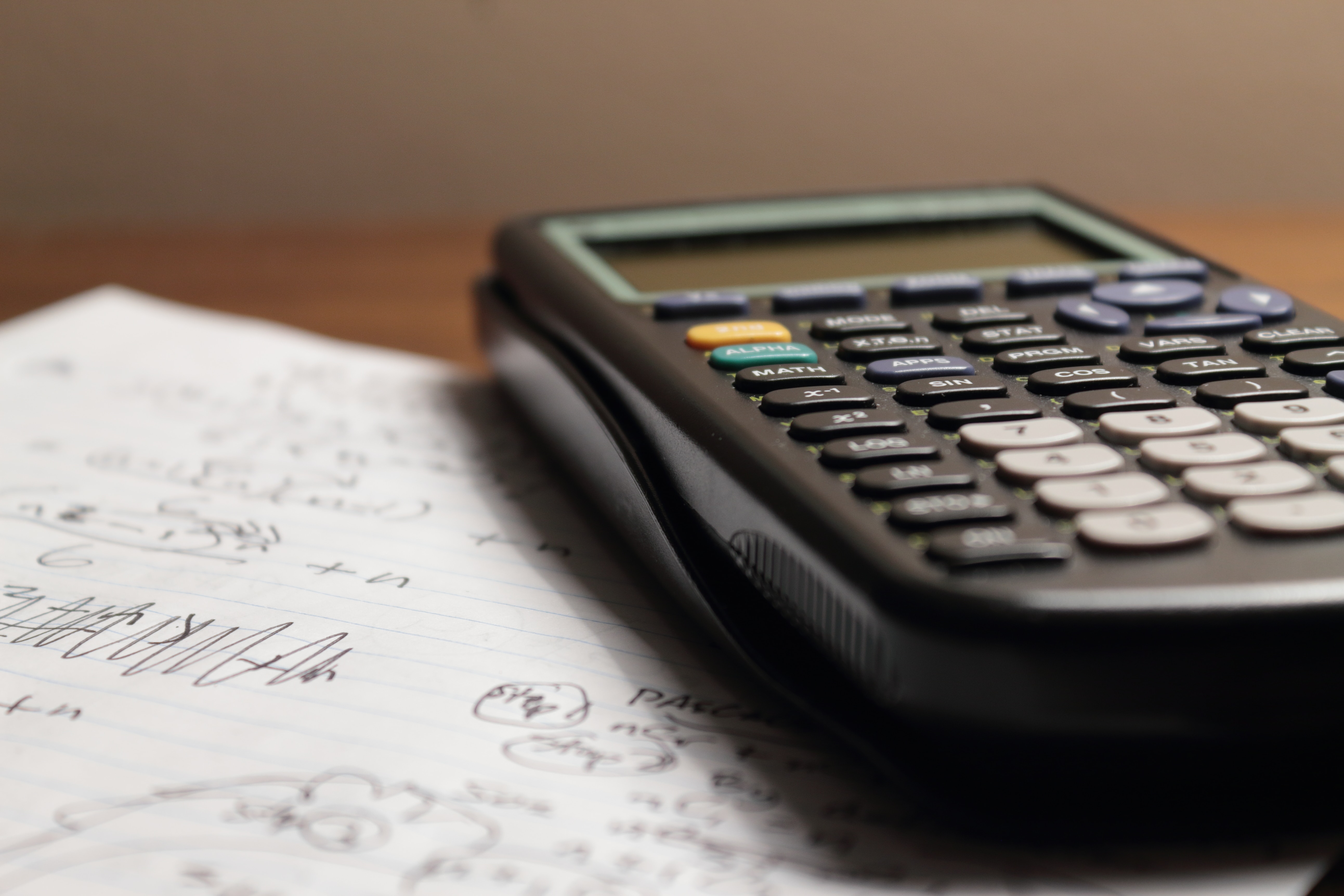 physical number chart and calculator on desk