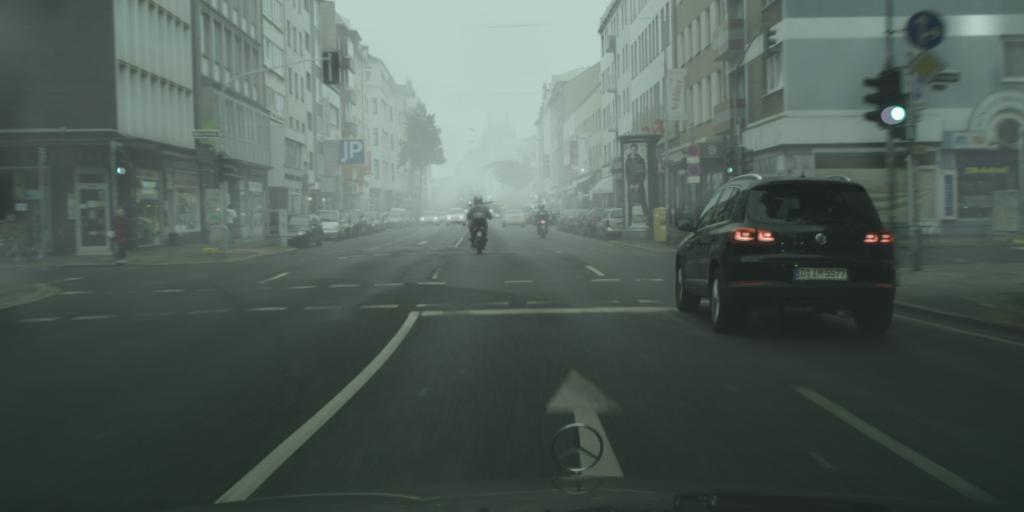 foggy cityscape with clear roads and vehicles
