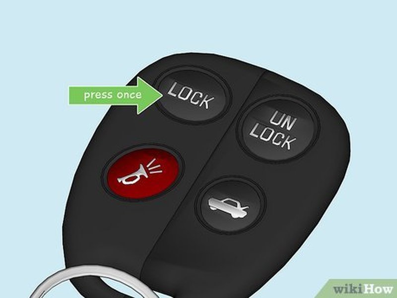 Close-up of a hand inserting a car key into an ignition, ready for programming