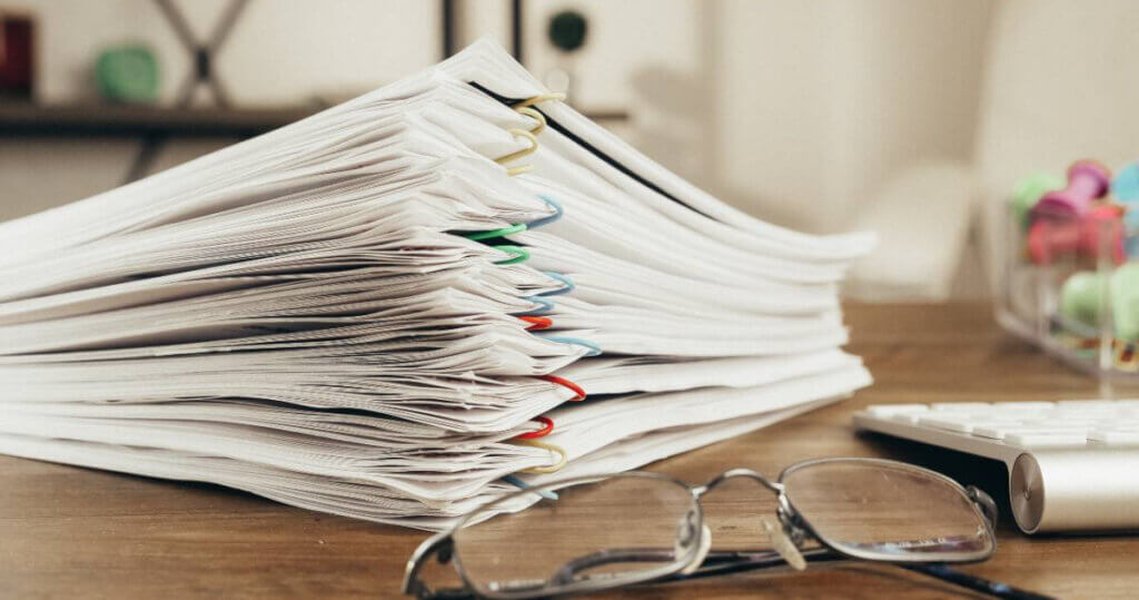 stacked documents on desk