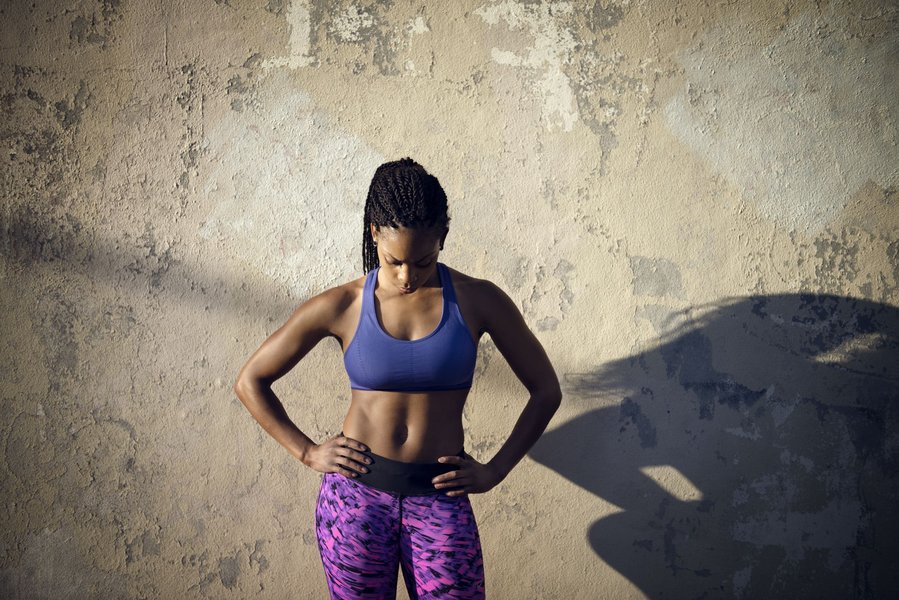 Woman assessing her body shape.