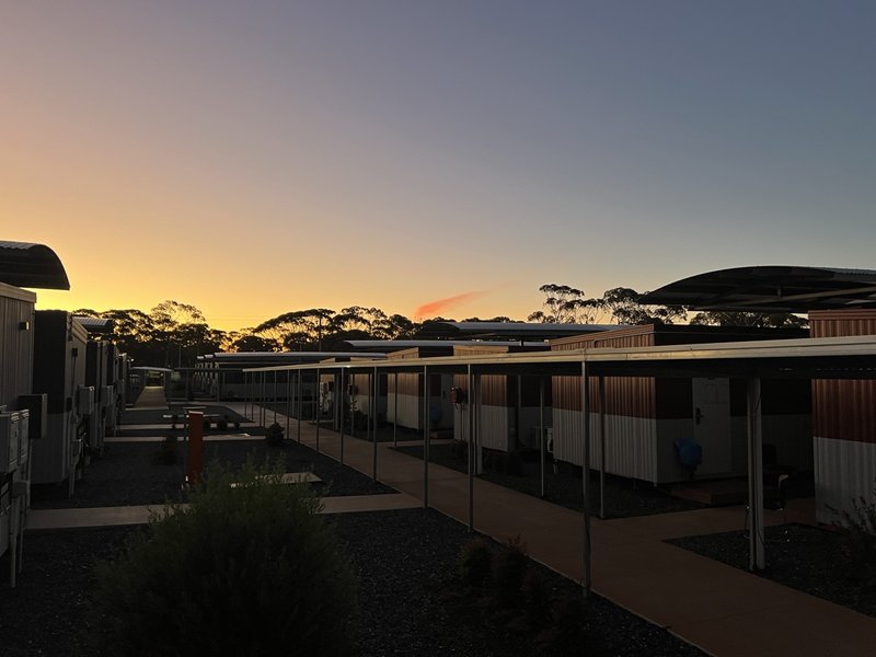 Rows of portable cabin accommodations in a worker's village or camp setting