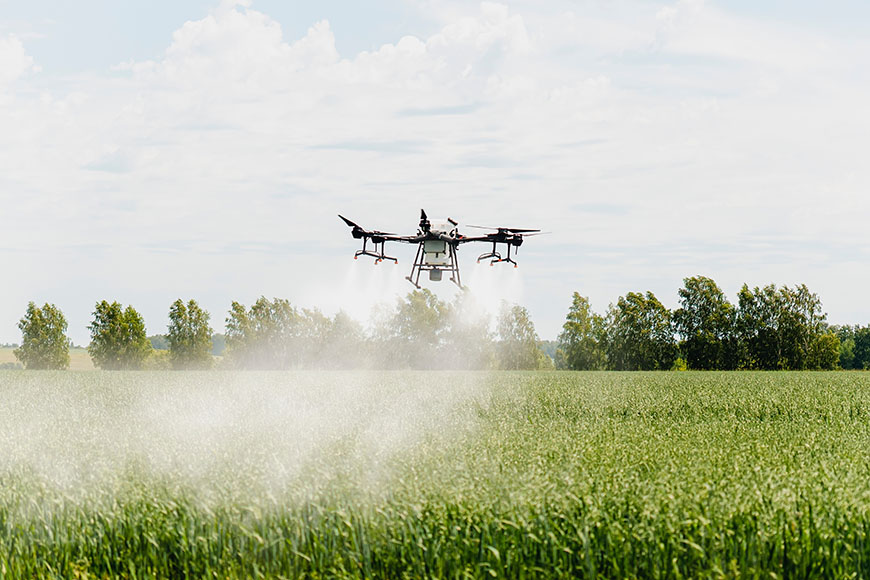 drones in flight over fields
