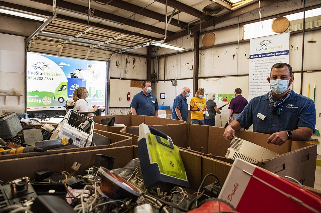 electronic waste recycling facility with people
