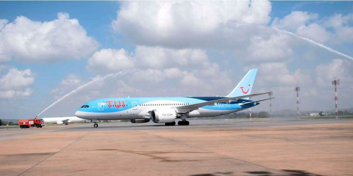 An airplane with TUI branding at an airport.