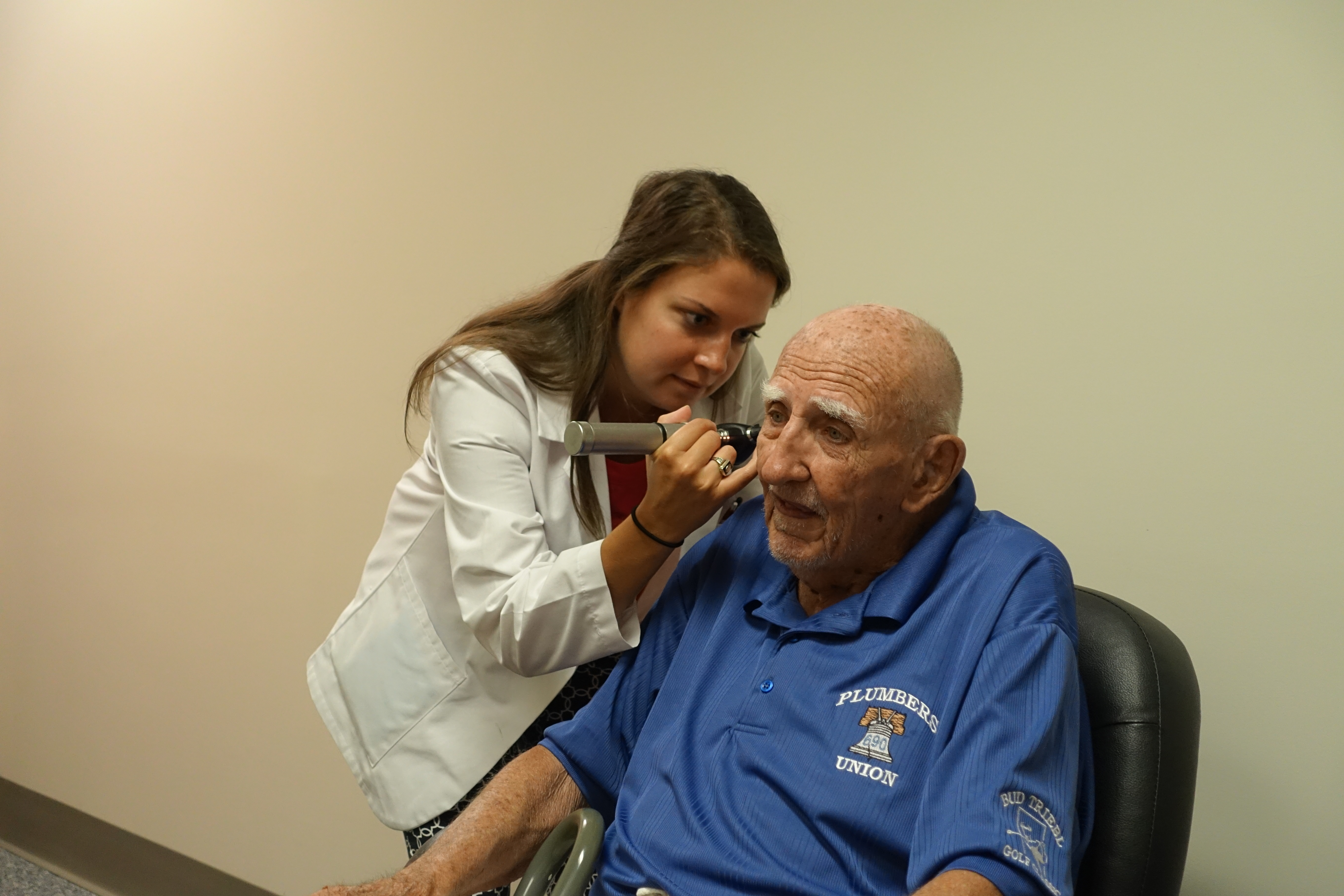 older man ear examination in clinic