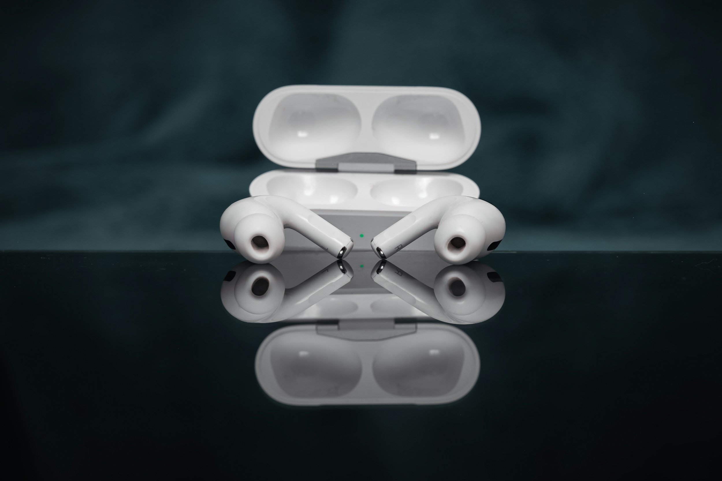 modern earbuds on a reflective surface