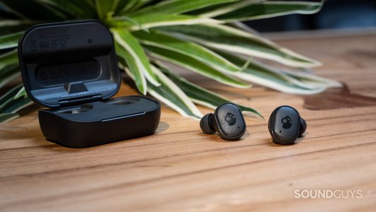 wireless earbuds on table with charging case