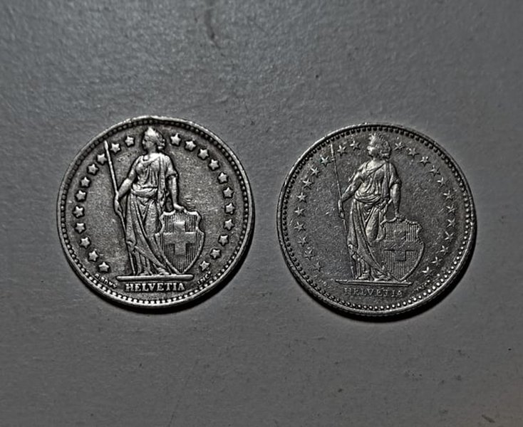 swiss dollar coins in metallic wallet
