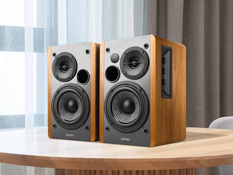 edifier speakers on wooden shelf