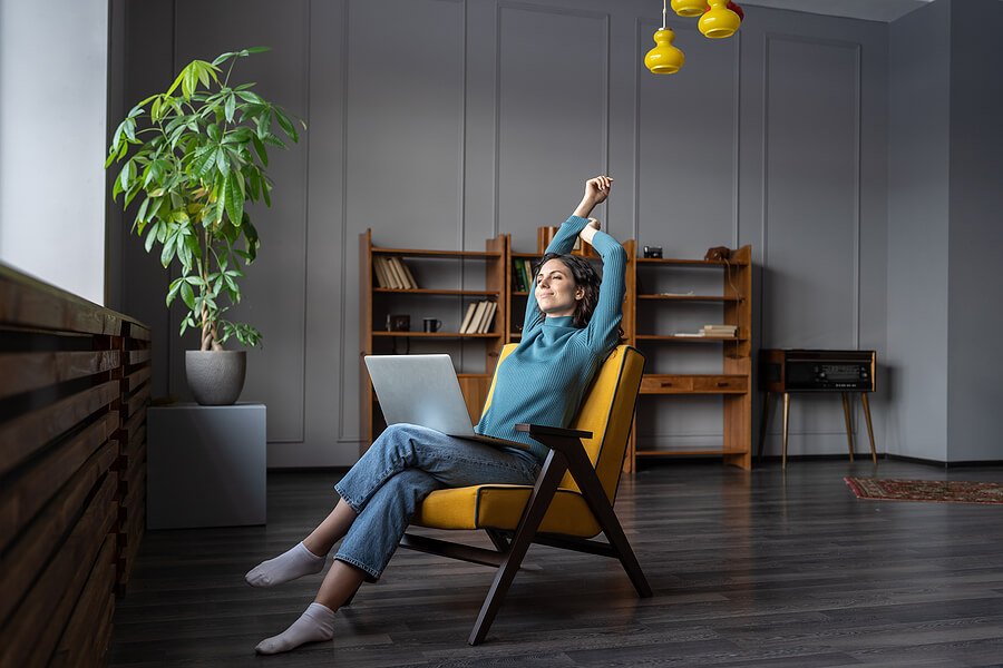 Woman relaxing and stretching in a comfortable home environment