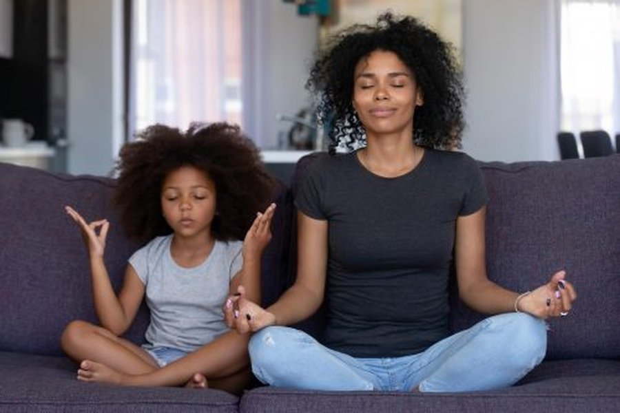 Mother and daughter doing yoga together