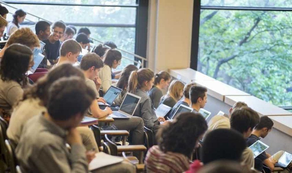 Professor engaging with students in a lecture setting