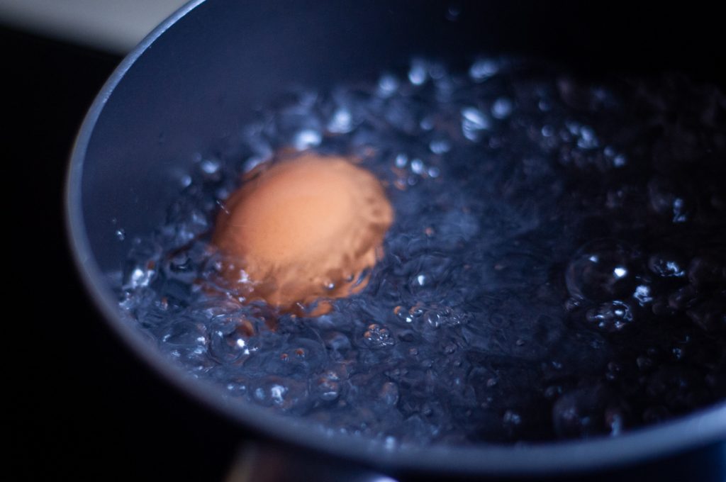 eggs boiling in a rustic kitchen