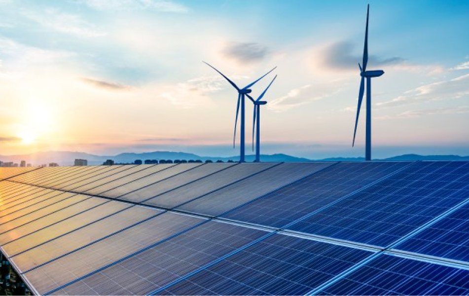 Rows of solar panels basking in the sun in a vast field.