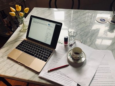desk with laptop, notes, and coffee