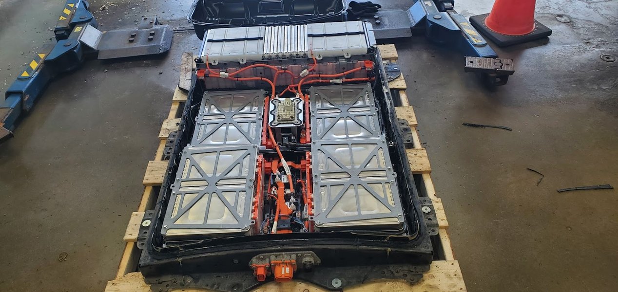 Individual battery modules being serviced within an EV battery pack