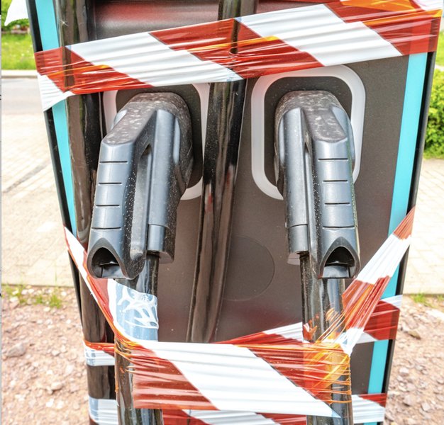 Illustration showing an electric vehicle charging station with security features, representing EV component protection.