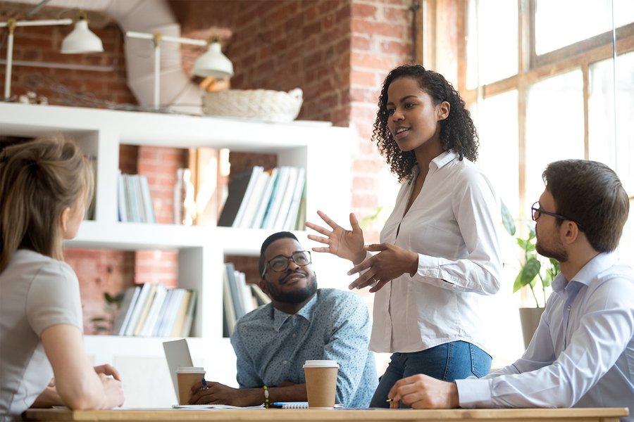 Diverse team collaborating during a stand-up meeting