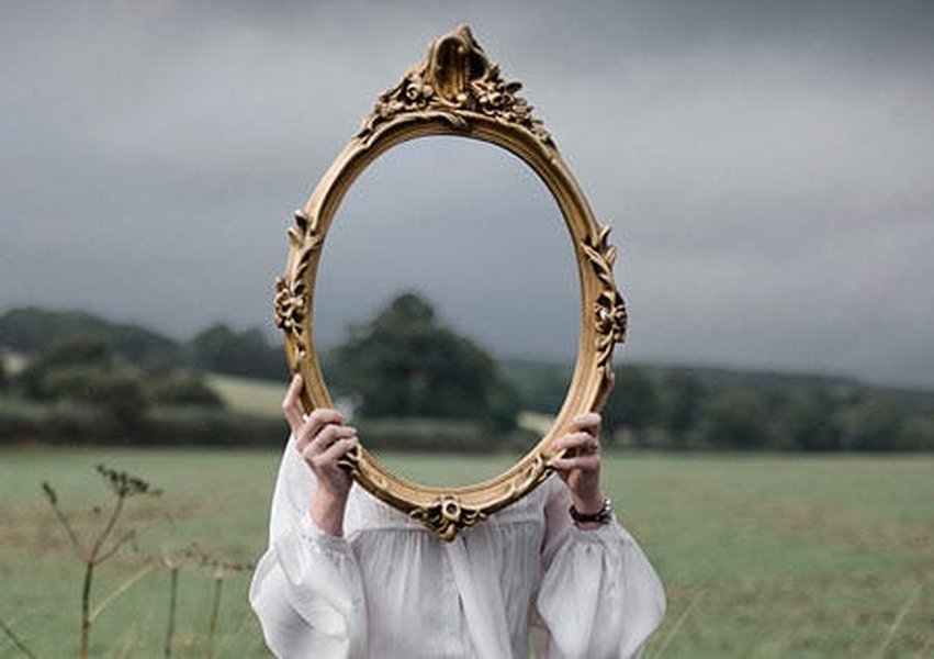 Person looking into a fragmented mirror