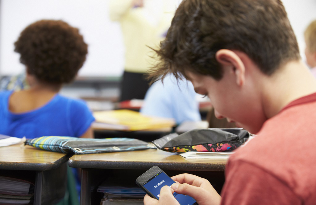 students using facebook in classroom