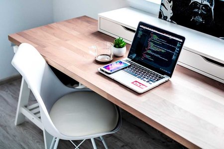 coding workspace with computer and notes