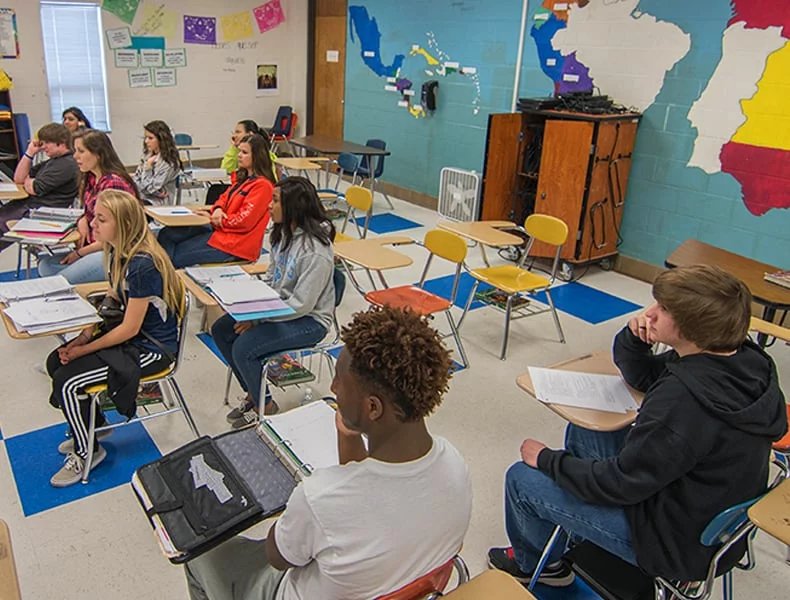 Teacher engaging students in a language classroom