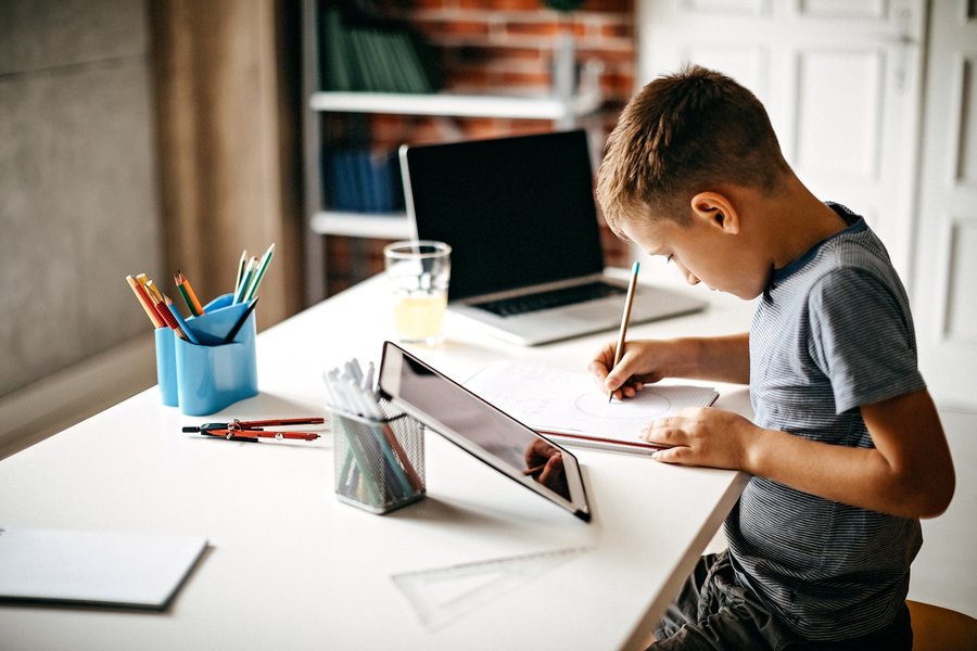 Child focused on studying at a desk, representing dedicated practice