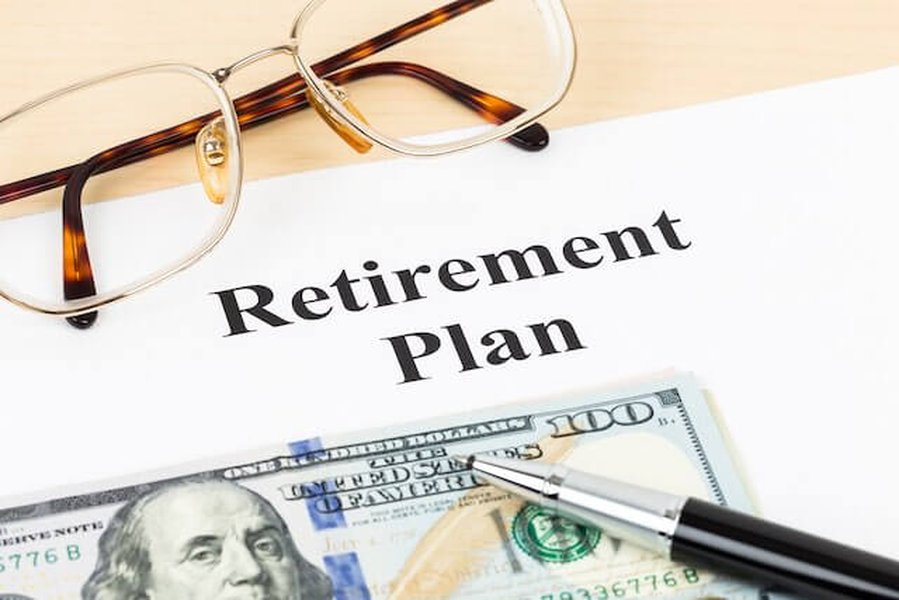 A document titled Retirement Plan with a pen and glasses