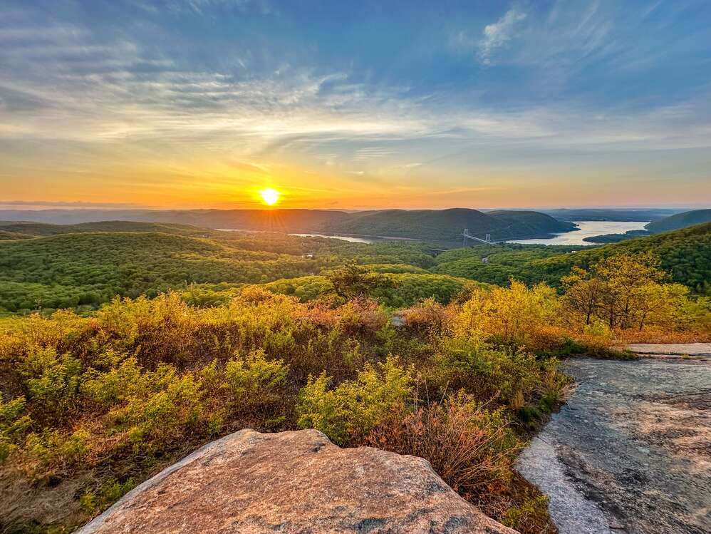 mountain landscape with sunrise illuminating a scenic path